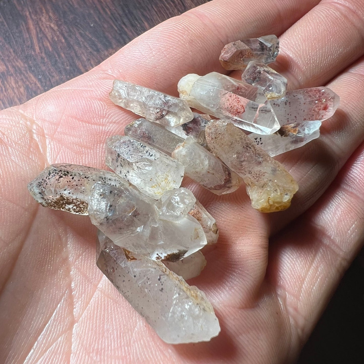 Quartz crystal with Hematite in palm