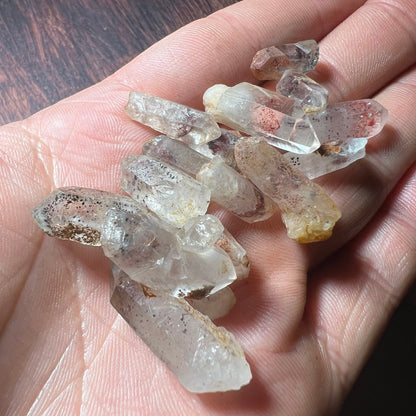 Quartz crystal with Hematite in palm